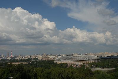 Buildings in city against cloudy sky