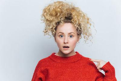 Portrait of young woman against white background