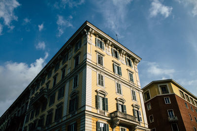 Low angle view of building against cloudy sky