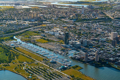 High angle view of road by river and buildings in city