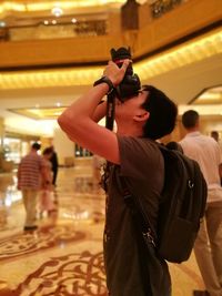 People photographing illuminated lamp