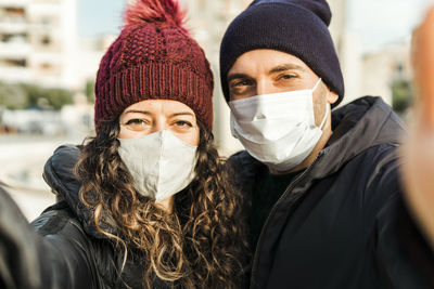 Portrait of woman with arms raised in winter