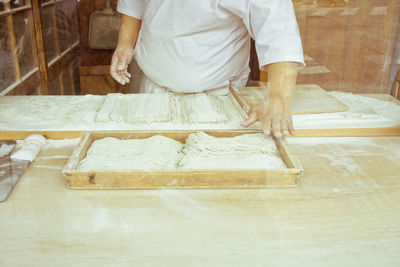 Midsection of man working on table