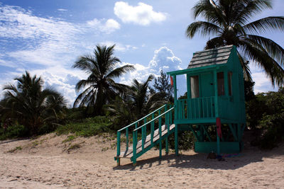 Lifeguard hut at beach against sky