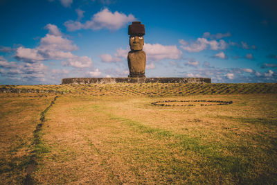 Stone wall on field against sky