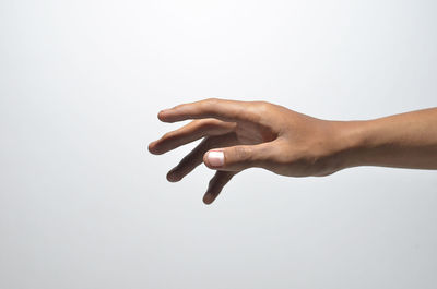 Close-up of woman hand over white background