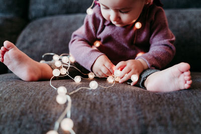 Midsection of woman playing with baby