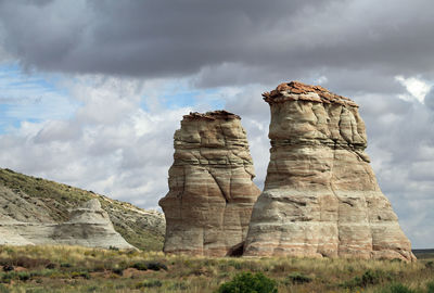 Low angle view of old ruins against cloudy sky