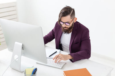 Mid adult man using laptop on table