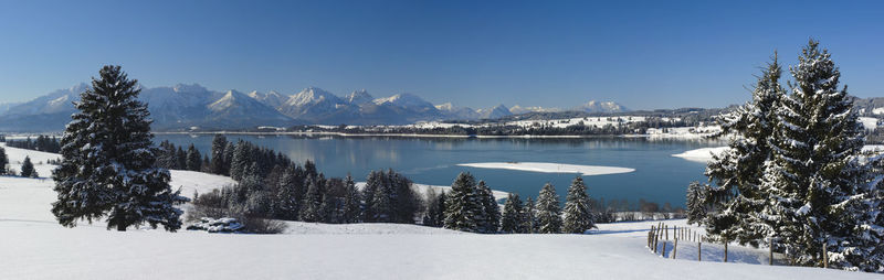 Scenic view of snow covered mountains against sky