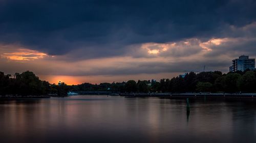 Scenic view of calm lake against cloudy sky