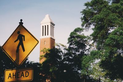 Low angle view of road sign against sky