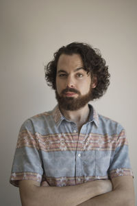 Portrait of a young man with his arms crossed