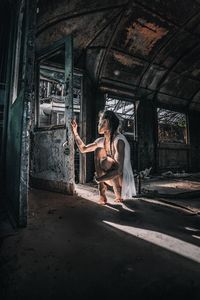 Woman standing in abandoned building