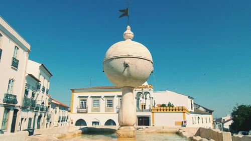 Low angle view of built structure against clear blue sky