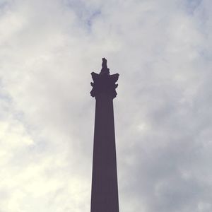 Low angle view of monument against cloudy sky