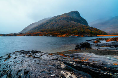 Scenic view of sea and mountains against sky