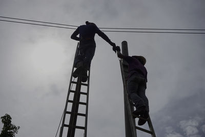 Low angle view of man standing against sky