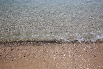 High angle view of waves rushing towards shore