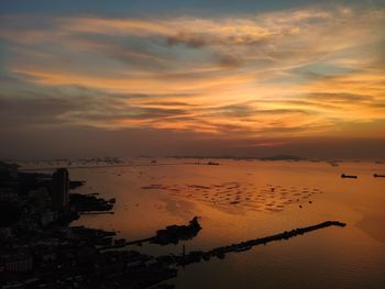 Scenic view of beach against sky during sunset