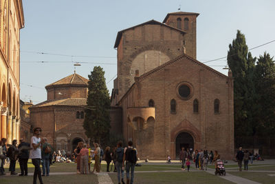 Group of people in historic building against sky