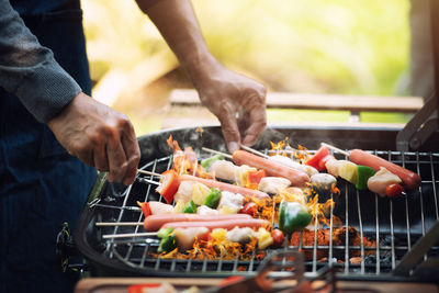 Man preparing food on barbecue grill