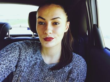 Close-up portrait of woman sitting in car