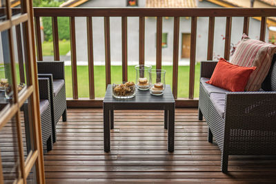 Rear view of woman sitting on railing