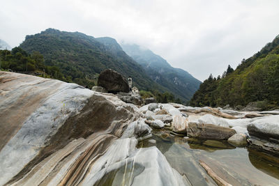 Scenic view of rocky mountains against cloudy sky