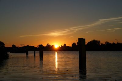 Scenic view of lake against sky during sunset