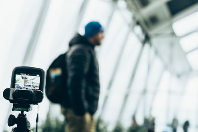 Close-up of man photographing through smart phone
