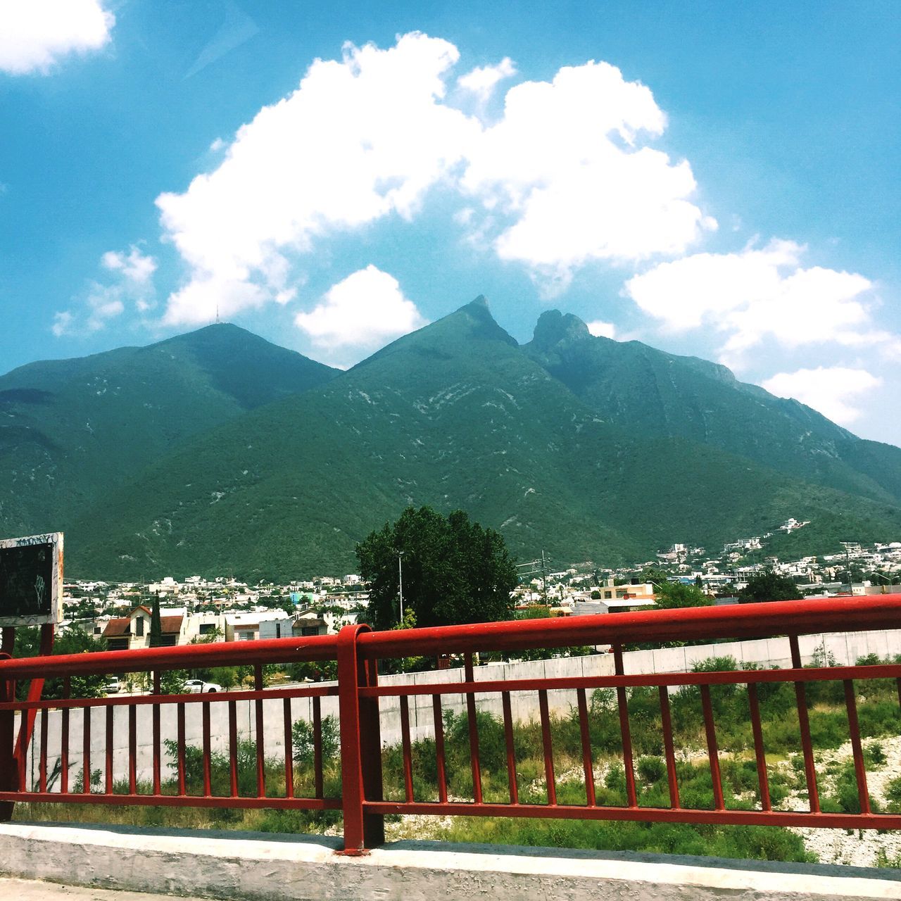 mountain, mountain range, sky, railing, built structure, architecture, cloud - sky, cloud, bridge - man made structure, connection, tranquility, beauty in nature, nature, scenics, tree, tranquil scene, river, transportation, day, landscape