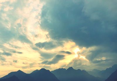 Low angle view of silhouette mountains against sky during sunset