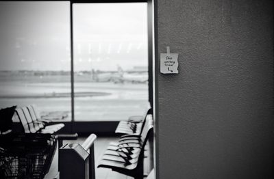 Adhesive note stuck on wall in airport building