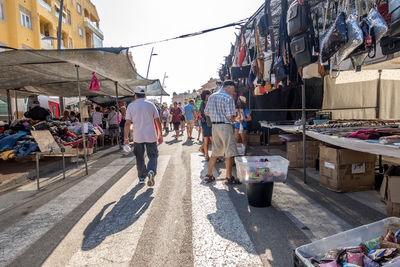 People walking on street market in city