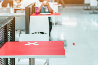 Close-up of empty chairs and tables in restaurant