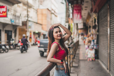 Portrait of smiling woman on street in city