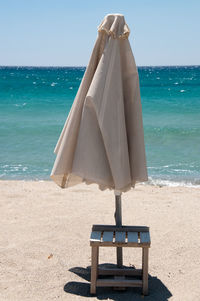 Lifeguard hut on beach against sky