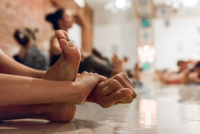 Cropped image of woman stretching on floor