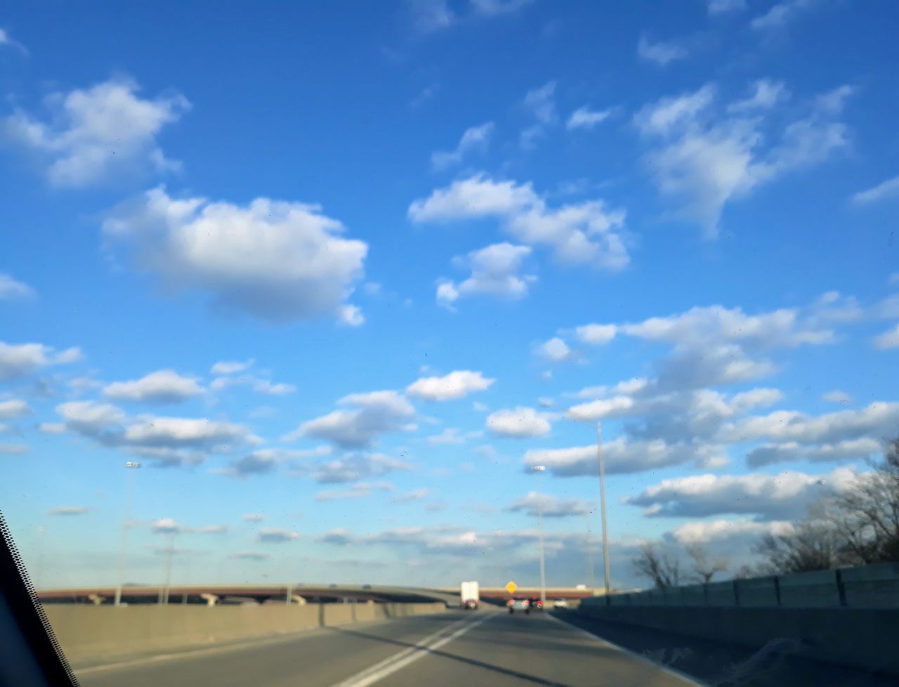 ROAD AGAINST SKY SEEN FROM WINDSHIELD