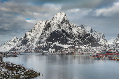 Scenic view of lake against mountain during winter