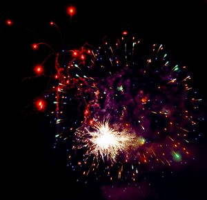 Low angle view of firework display at night