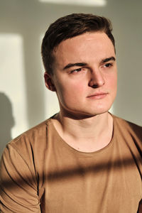 Handsome young man in t-shirt and jeans alone