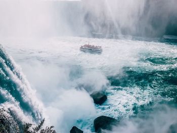 Scenic view of waterfall against sky