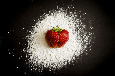 Close-up of strawberry over black background