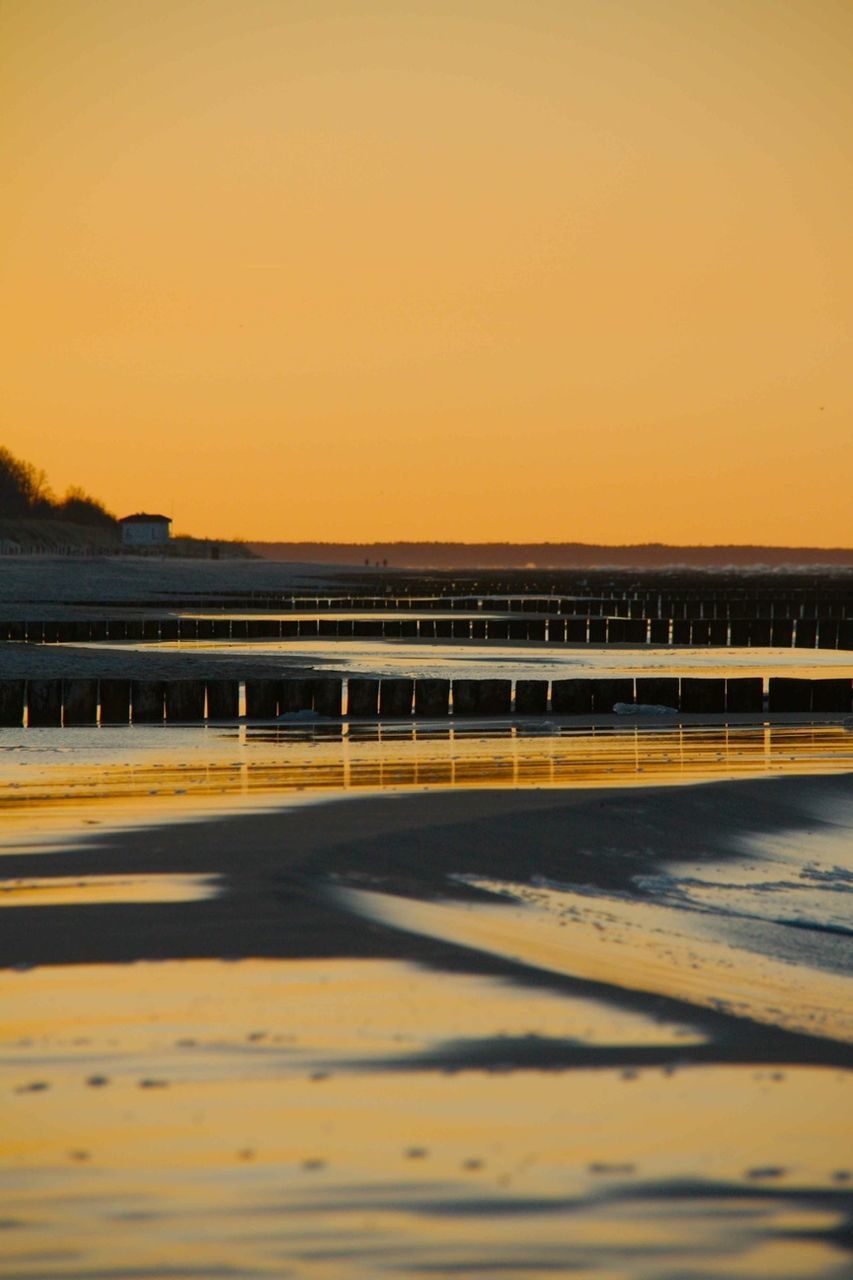 sunset, transportation, built structure, clear sky, architecture, copy space, bridge - man made structure, connection, orange color, road, sky, water, yellow, the way forward, bridge, railing, outdoors, no people, dusk, diminishing perspective