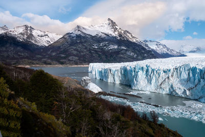 Scenic view of frozen river and mountain against sky