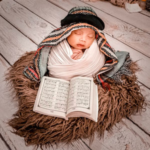 High angle view of baby boy on book