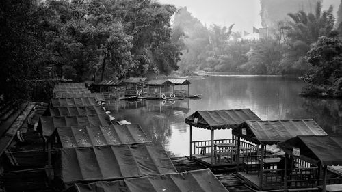 High angle view of houseboats moored in river during foggy weather