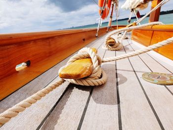 Close-up of rope on wooden rope on yacht deck